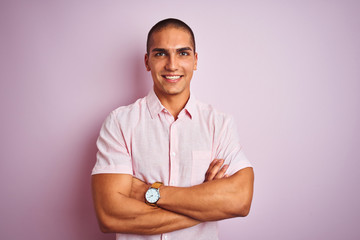 Young handsome man wearing elegant shirt over pink isolated background happy face smiling with crossed arms looking at the camera. Positive person.