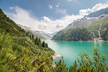 Scenic view of a beautiful turquoise colored lake in the Alps