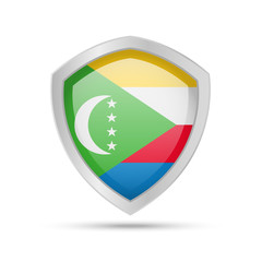 Shield with Comoros flag on white background. Vector illustration.