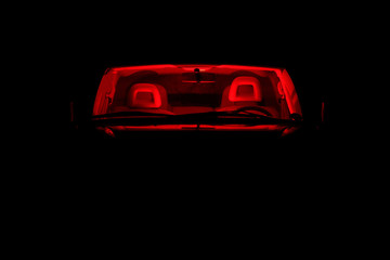 Obraz na płótnie Canvas car with a red light inside on a dark night.