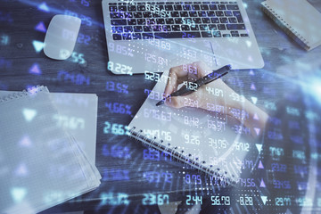 Forex chart displayed on woman's hand taking notes background. Concept of research. Multi exposure