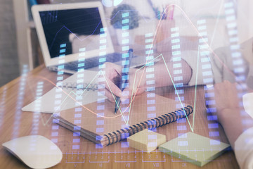 Financial charts displayed on woman's hand taking notes background. Concept of research. Double exposure