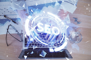 Double exposure of seo icon with man working on computer on background. Concept of search engine optimization.