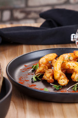 Delicious fried shrimp with fresh sliced avocado on dark plate. Food flat lay. Brealfast food. Seafood. Copy space for design. Food for dating