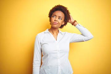 African american business woman over isolated yellow background confuse and wondering about...