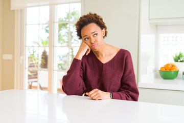 Young beautiful african american woman at home thinking looking tired and bored with depression problems with crossed arms.