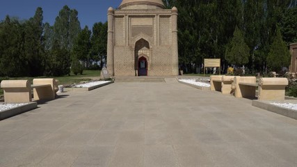  Taraz Aisha Bibi Mausoleum Frontal View with Sitting Benches and Trees at Background on a Sunny Blue Sky Day