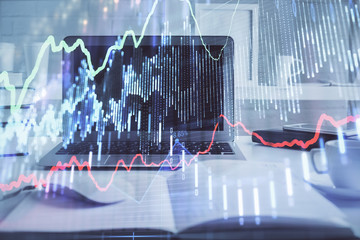 Stock market graph on background with desk and personal computer. Double exposure. Concept of financial analysis.