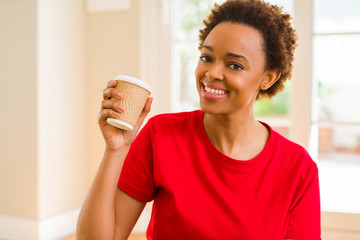 Beautiful young african american woman drinking a coffee in a take away paper cup