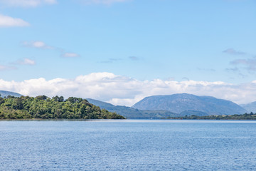 Fototapeta na wymiar Forest in Inchagoill Island with Conemara mountains in background