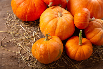Colorful pumpkins on wooden table. Autumn harvest background