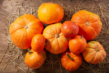 Orange pumpkins on wooden table. Autumn harvest background