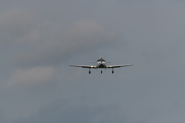 Fototapeta na wymiar a landing plane on a gray background