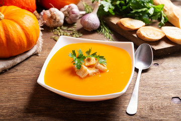 bowl of pumpkin soup with ingredients for cooking