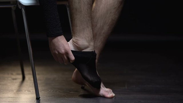 Crossdresser wearing pantyhose, preparing for transgender party or date, closeup