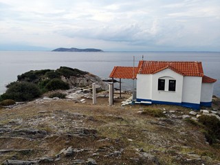 Fototapeta na wymiar Thasos island symbol, the Two Apostoles Church near Karnagio Beach and Limenas Town.