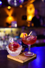 Red cocktail in night club