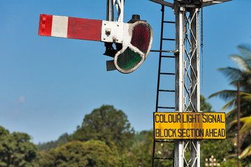An old British semaphore mounted on a railway in Sri Lanka indicates that the road is closed.