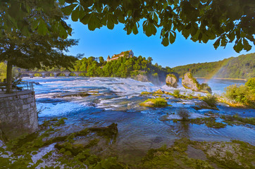 Early in the morning at sunrise, a few hours before onslaught of tourists, at the Rhine Falls, near the city of Schaffhausen,, more precisely in Neuhausen, Switzerland. Summer 2019, month of August.