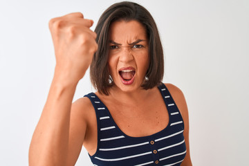 Young beautiful woman wearing blue striped t-shirt standing over isolated white background annoyed and frustrated shouting with anger, crazy and yelling with raised hand, anger concept