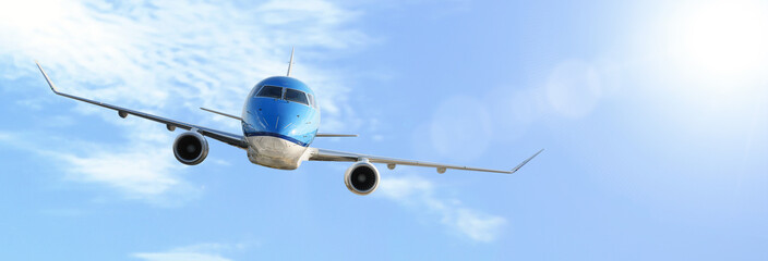 Aerial industry advertisement - generic modern passenger airplane flying above clouds in deep sunlights (copy space).