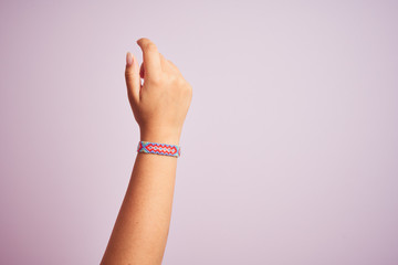 Model arm with beautiful handmade colorful bracelet on wrist