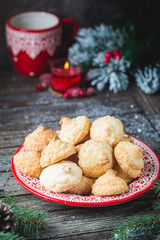 Homemade Christmas cookies in a red plate with festive decoration