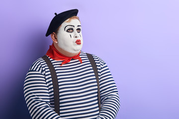 plump pensive thoughtful clown looking up, whistling . Pantomime and emotion concept.copy space....