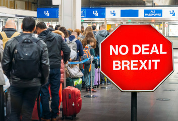 No Deal Brexit digital composite with people queuing at passport control within generic EU airport