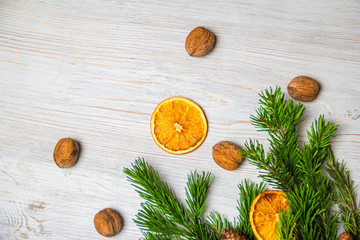 Obraz na płótnie Canvas Christmas and New Year composition. Pine branches, cinnamon sticks, dried slices of orange and walnuts. Christmas and New Year concept. Flat lay.