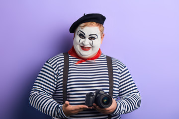 cheerful smiling performer showing professional digital camera. close up photo. advert , sale,...