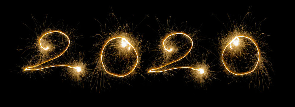 Happy New Year 2020.  written sparkling sparklers on black background with copy space.Number 2020.Template for holiday greeting card.