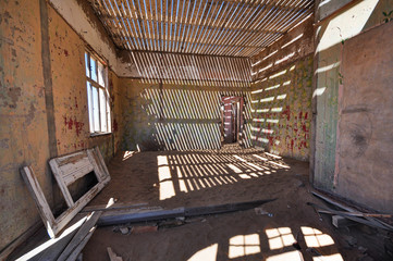 Inside an abandoned house in the mining ghost town of Kolmanskop in Namibia
