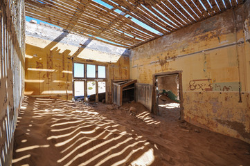 Inside an abandoned house in the mining ghost town of Kolmanskop in Namibia