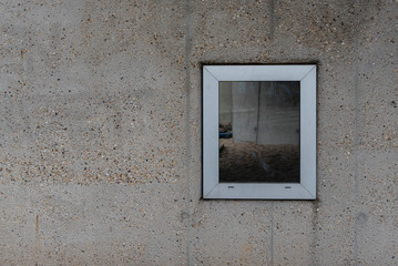 Window on a concrete wall, One Window on a bare Facade, bare Wall with a Window