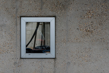 Window on a concrete wall, One Window on a bare Facade, bare Wall with a Window