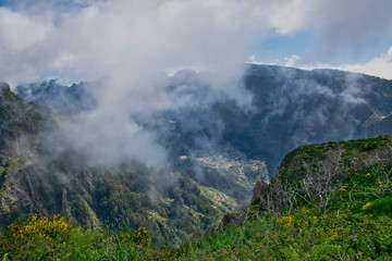 View from the hiking trail at the Boca da Corrida belvedere on the Encumeada pass on Madeira Island, Portugal in summer, View to the village of Curral das Freiras 
