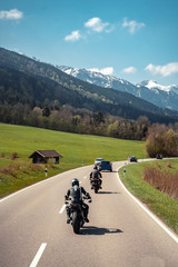 Two biker riding alone on mountainous road