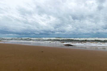 Fototapeta na wymiar beautiful waves going to the coast, stormy sea with thunder clouds over,
