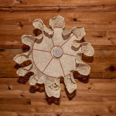 Wooden ceiling lamp with white cotton shade.