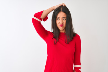 Young beautiful chinese woman wearing red dress standing over isolated white background confuse and wonder about question. Uncertain with doubt, thinking with hand on head. Pensive concept.