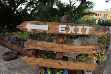 Fototapeta na wymiar wooden exit sign board showing direction