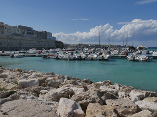 Otranto southern promenade along the walls. Otranto rocky and jagged beach and its southern...