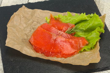 Sliced salmon fillet served rosemary