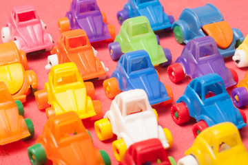 Naklejka premium Toys plastic cars on a red background