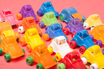 Naklejka premium Toys plastic cars on a red background