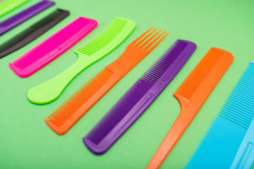 Plastic combs isolated on green background