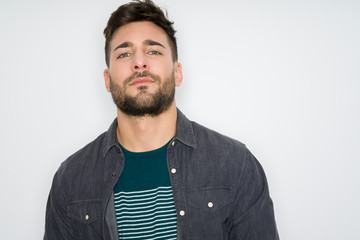Young handsome man possing and modeling over grey isolated background
