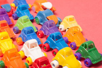 Naklejka premium Toys plastic cars on a red background