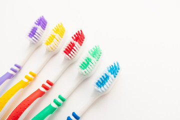 set of plastic toothbrushes on white background